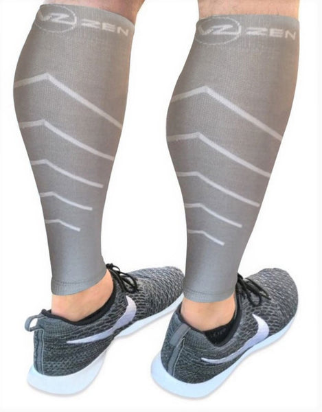 grey calf compression sleeve on legs with arrows pointing up vin zen compression stockings