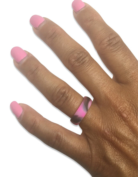 pink camo silicone wedding ring on a womans hand with pink nails 