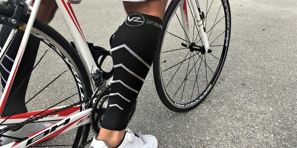 calf compression sleeve on a mans leg riding a bicycle compression stockings